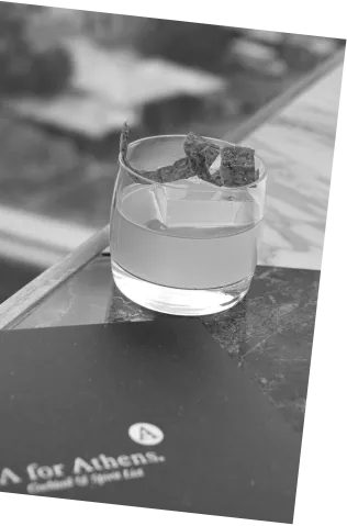 Black and white picture of an Axia Mastiha Spirit with A for Athens Cupid Cocktail on a bar