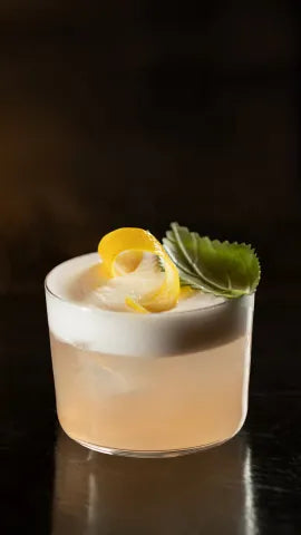 Axia Spirit and Baba au Rum Axia Sour Cocktail on a table