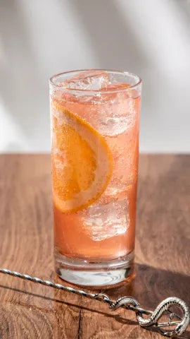 Axia Aegean Paloma Cocktail on a wooden table