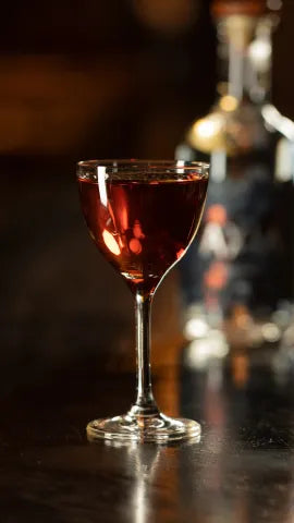 Axia Classic Cocktail on a bar with an Axia bottle in the background