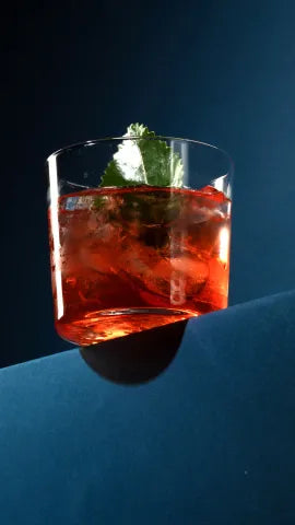 Axia Mediterranean Negroni Cocktail on a dark blue background
