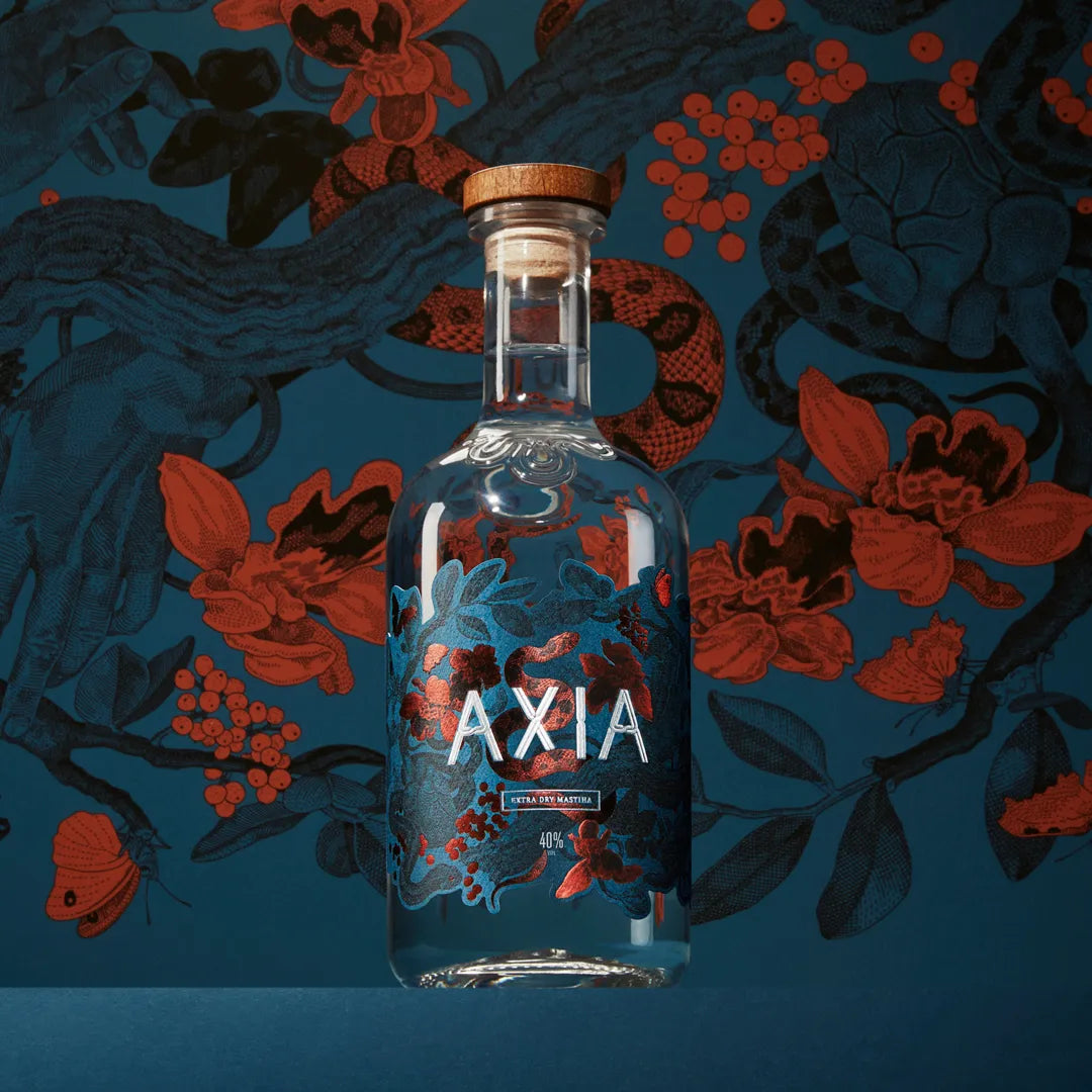Bottle of Axia Mastiha Spirit on a dark blue background with red flower and snake illustrations