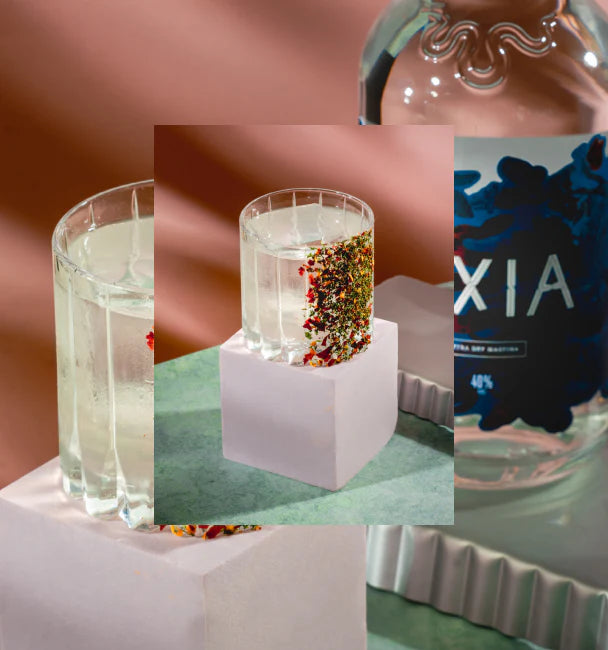 Black and white picture of an Axia Greek Mastiha Spirit and Gaucho Chimichurri Margarita Cocktail with a secondary close-up picture in the background of another Chimichurri Margarita cocktail next to an Axia Extra Dry Mastiha Spirit bottle